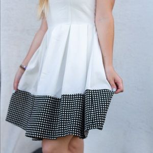 White dress with full skirt and black trim
